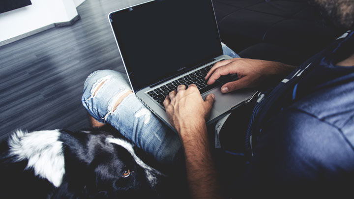 man's hands on a laptop
