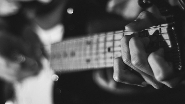 strumming a guitar