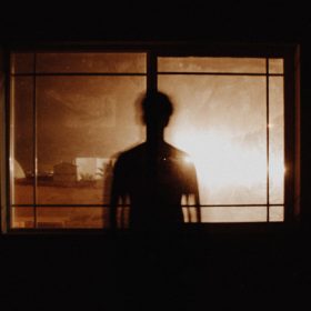 man's silhouette at the window