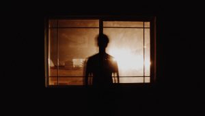 man's silhouette at the window