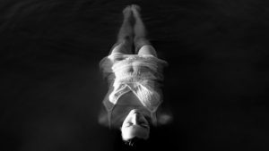 a woman floating in water - imagery for "Swimming with Angels" by Anna Geary-Meyer