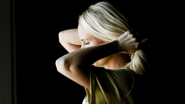 woman pulling hair back - image for "Let Down Your Hair" by Carla Kirchner
