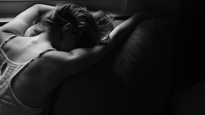 A woman lying face down, image for Her Skin by Lucy Palmer